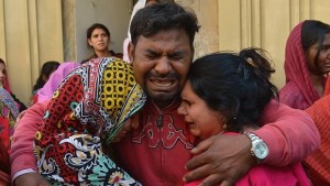 Familiares de una de las decenas de víctimas lloran durante el entierro en Lahore - AFP